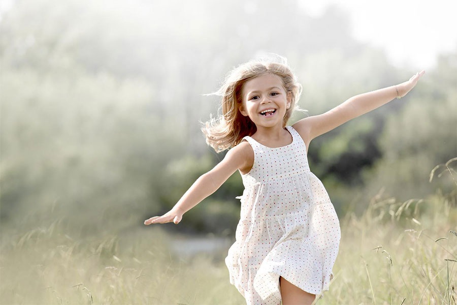 Smiling girl running on the field